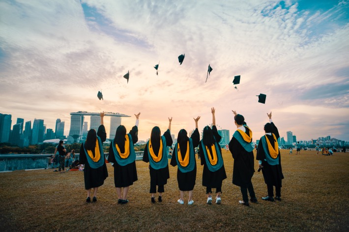 University graduation ceremony, students throwing their hats in the air