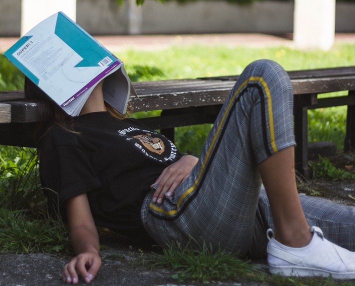 A person fell asleep with a book over her head