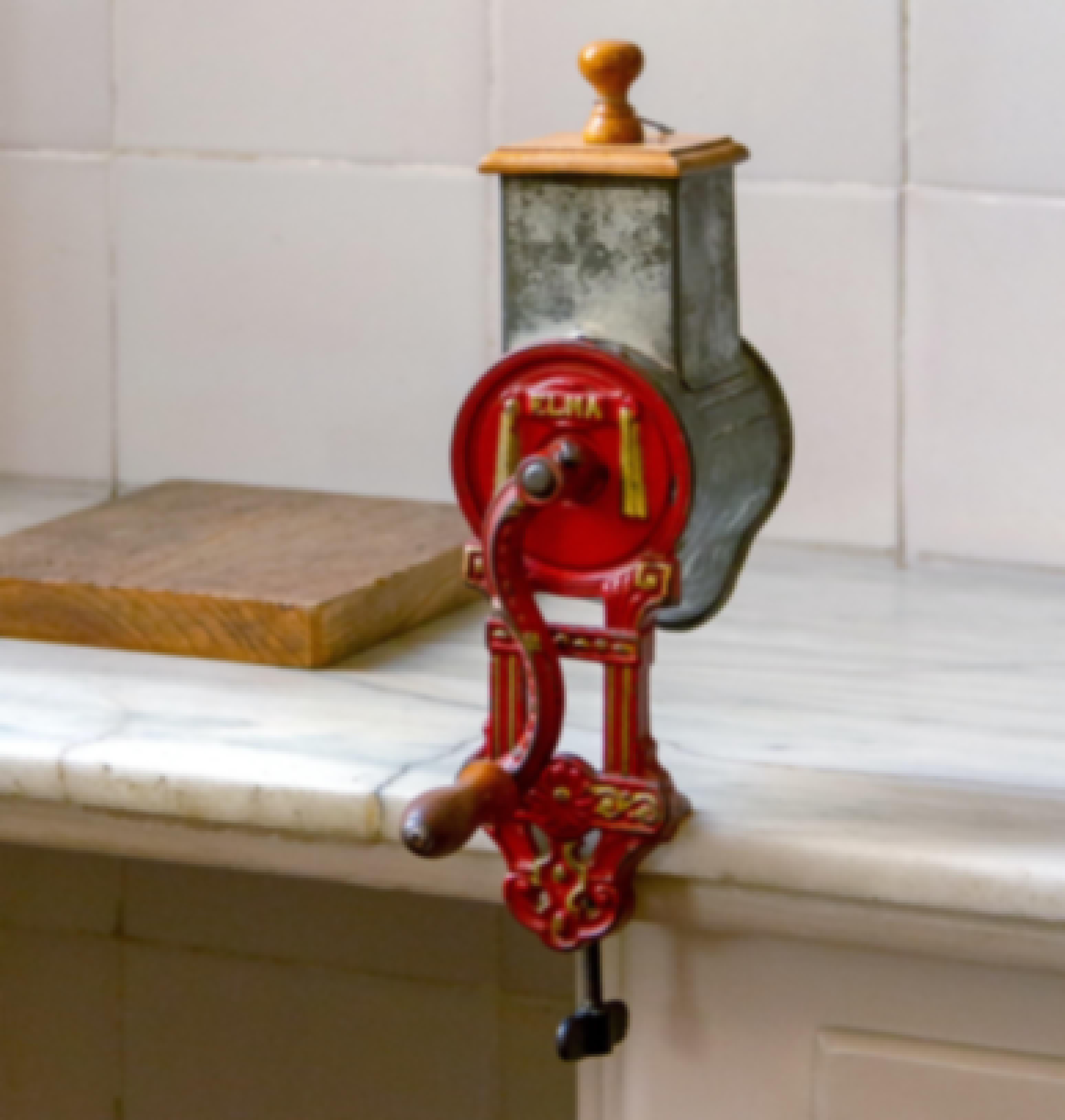 Old manual grinder attached to a tabletop