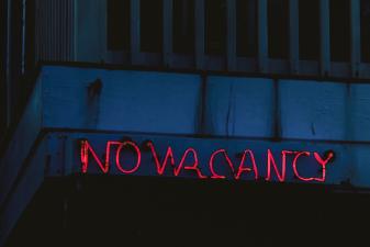 Hotel with a 100% occupancy rate displaying a no vacancy photo