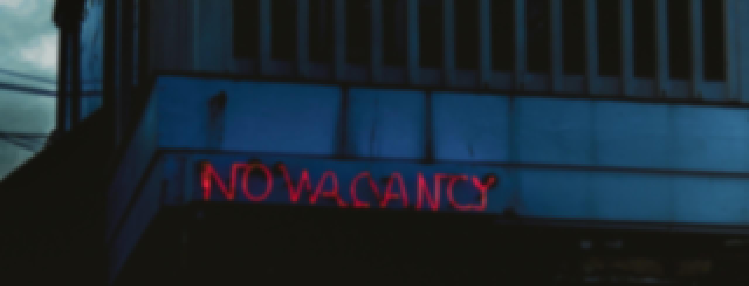 Hotel with a 100% occupancy rate displaying a no vacancy photo